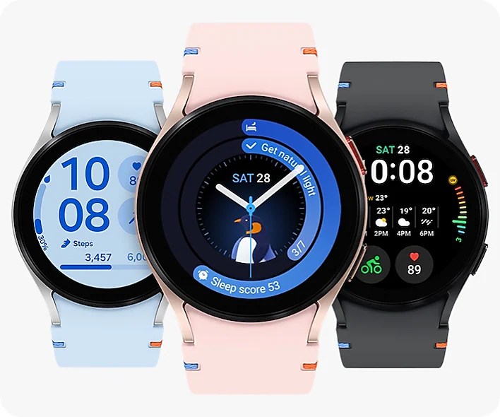 Three Samsung Galaxy Watch FE smartwatches in various colors: pink gold, light blue, and black, showcasing different watch faces and fitness tracking features.